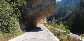 The road cut into the rock in the canyon